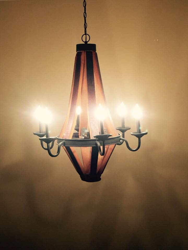 Chandelier with five lights hanging from it, showcasing an elegant design, installed by an electrician.